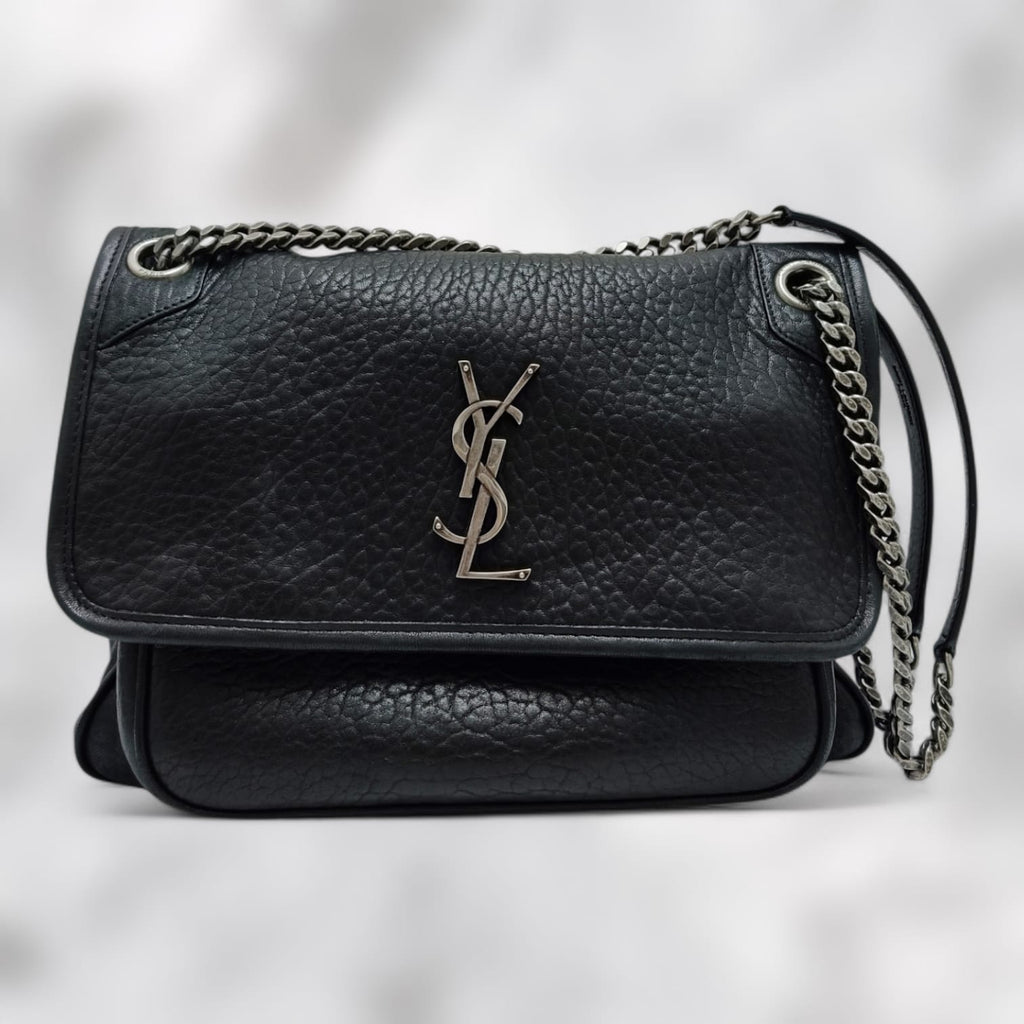 ysl Black leather handbag with chain strap on a light gray background